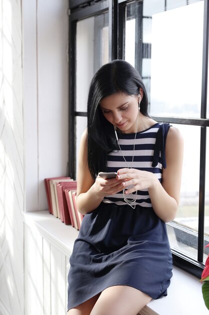 Beautiful woman listening to music with earphones