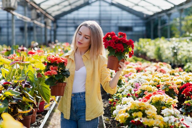 Beautiful woman looking out for flowers