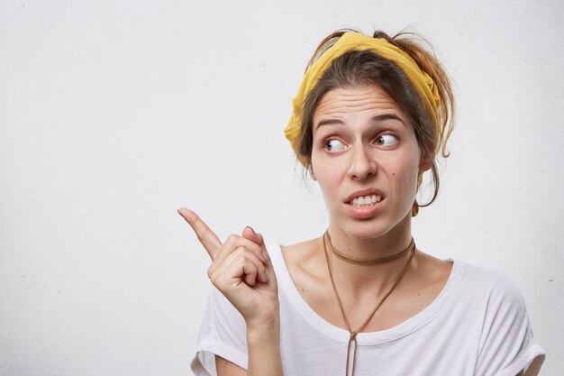 Beautiful woman looking at something with a disgusting look