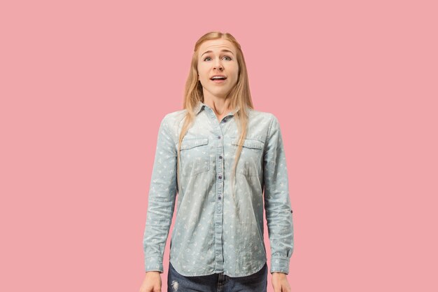 Beautiful woman looking suprised isolated on pink