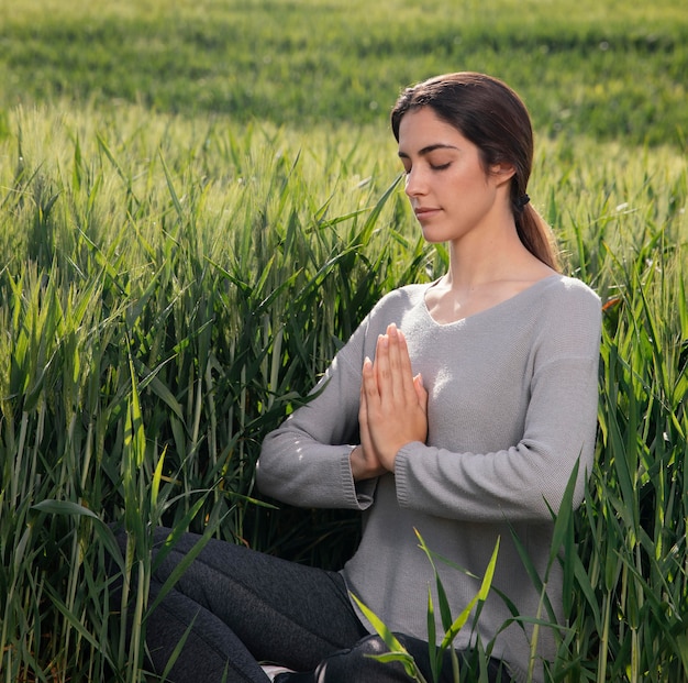 Foto gratuita bella donna che medita nella natura