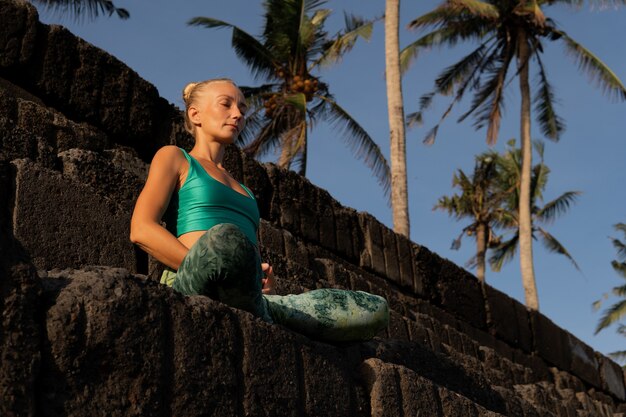 Beautiful woman meditating outdoors