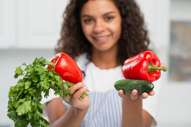 Beautiful woman offering delicious vegetables