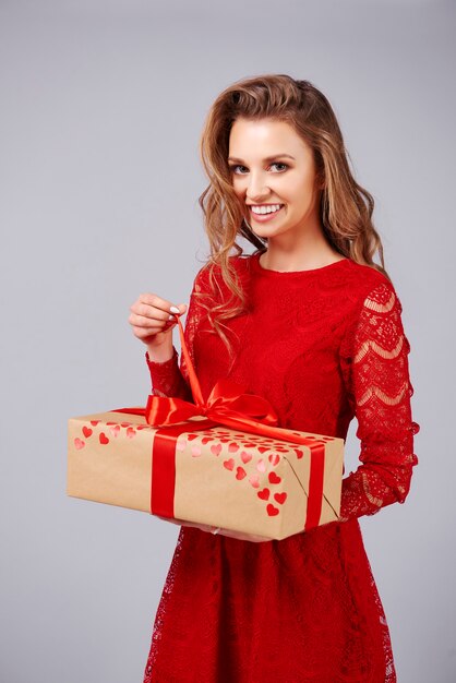 Beautiful woman opening a big gift