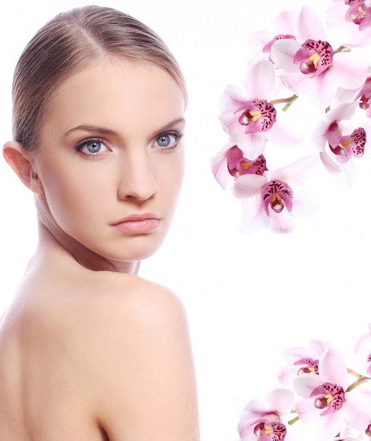 Free photo beautiful woman and orchid flowers