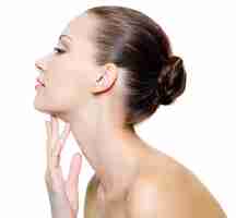 Free photo beautiful woman pampering the neck  - on white background. profile portrait.