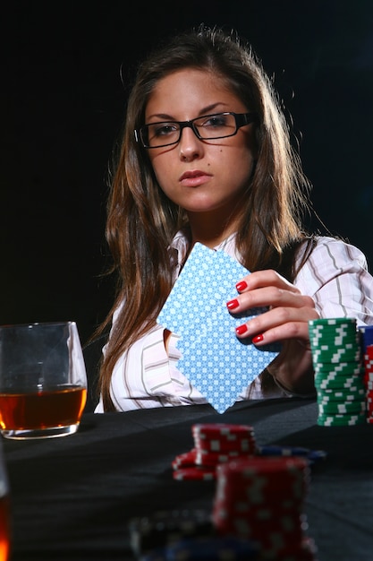 Free photo beautiful woman playing poker