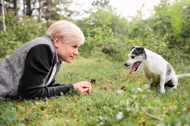 Beautiful woman playing with her dog in the park