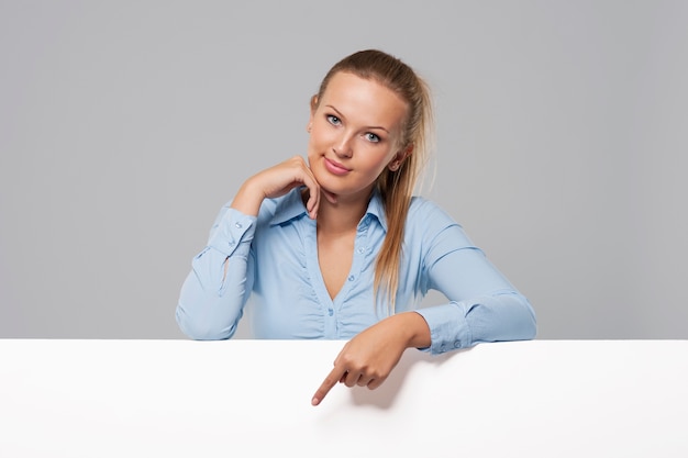 Beautiful woman pointing on whiteboard