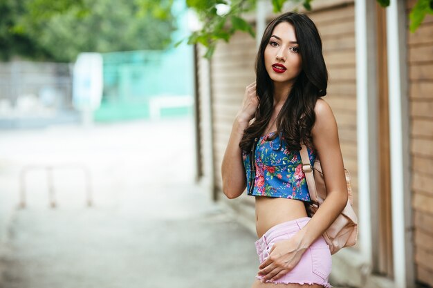 Beautiful woman poses in the city on the street