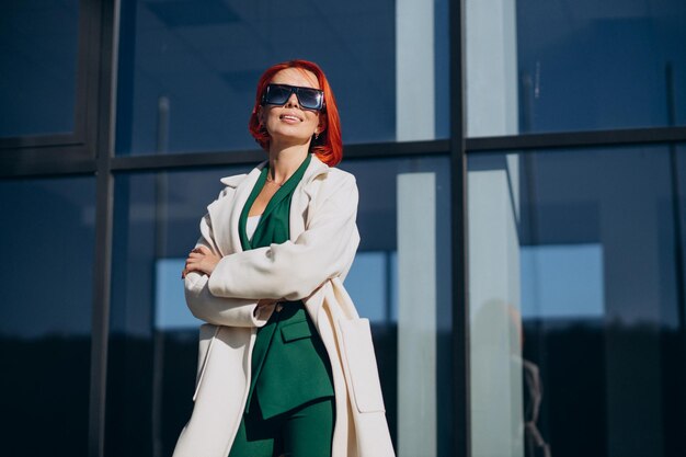 Beautiful woman posing in autumn coat posing in the street