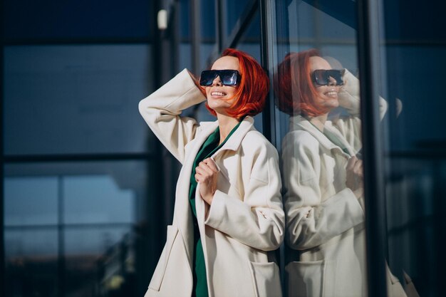 Beautiful woman posing in autumn coat posing in the street