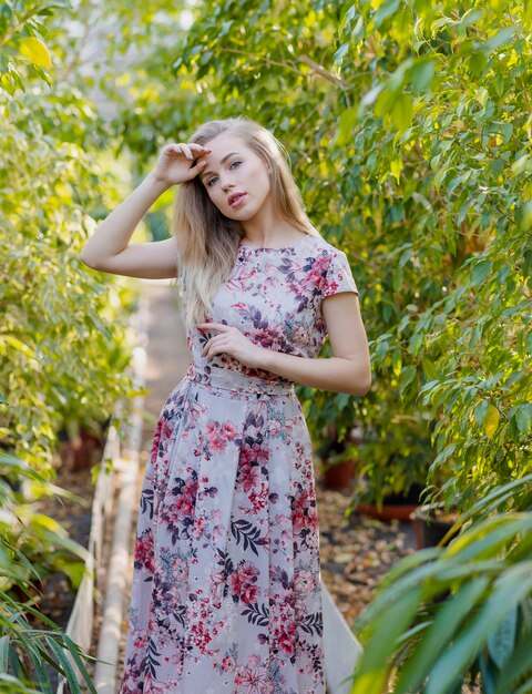 Beautiful woman posing in greenhouse