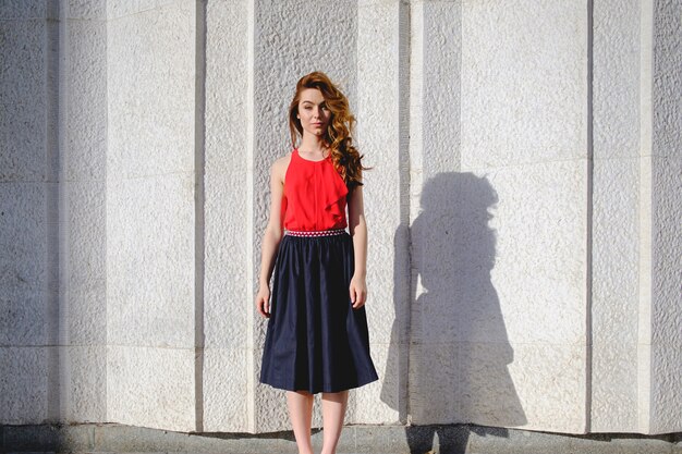 Beautiful woman posing on an urban wall