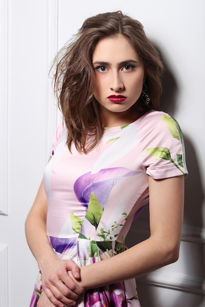 Beautiful woman posing with colorful floral dress