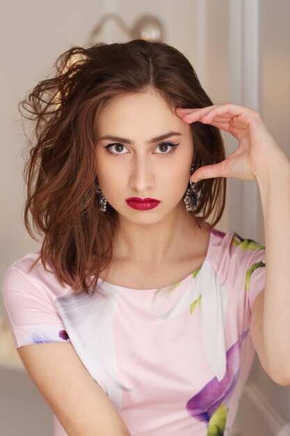 Beautiful woman posing with colorful floral dress