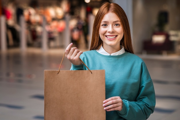 Beautiful woman posing with paper bag