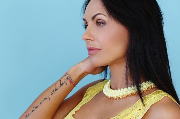 Beautiful woman posing with yellow t-shirt