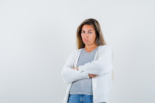 Beautiful woman pouting lips in jacket and looking dissatisfied. front view.