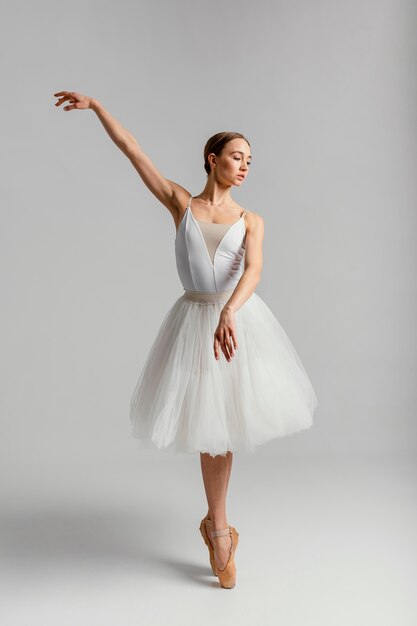 Beautiful woman practicing ballet full shot