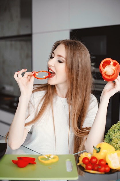 Beautiful woman prepare food in a kitchen