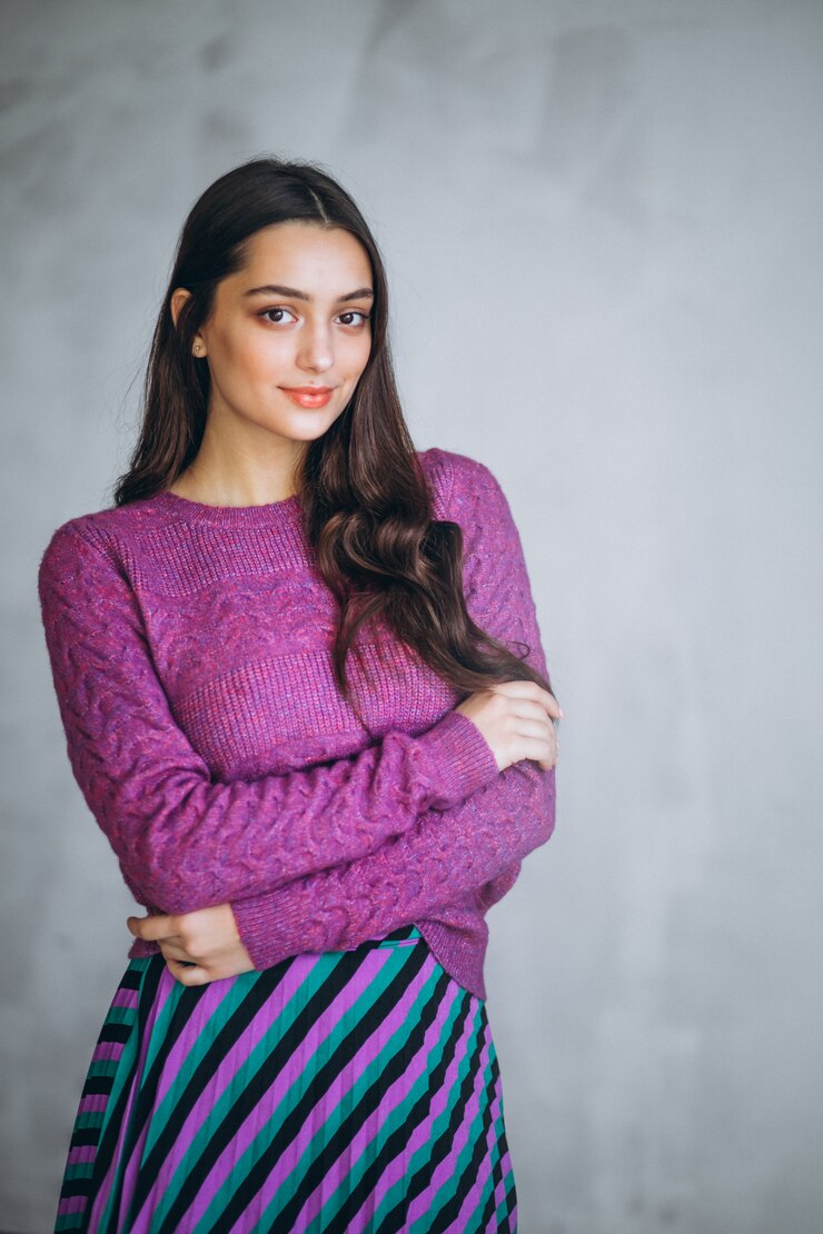 Free Photo beautiful woman in a purple sweater and skirt