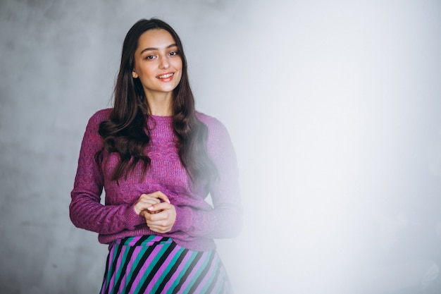 Beautiful woman in a purple sweater and skirt