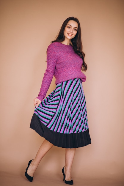 Free photo beautiful woman in a purple sweater and skirt