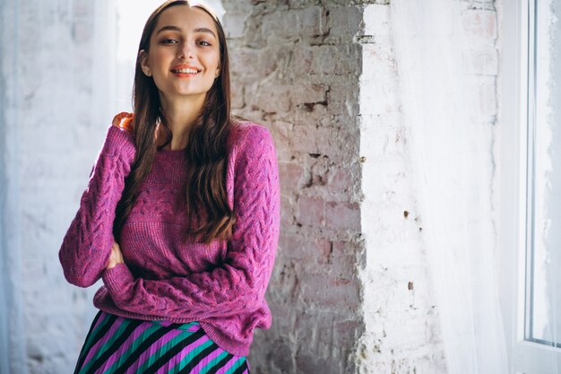 Beautiful woman in a purple sweater and skirt