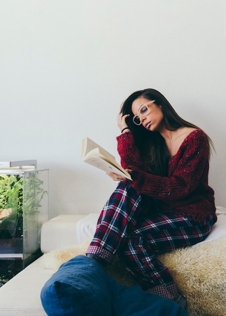 Free photo beautiful woman reading on sofa