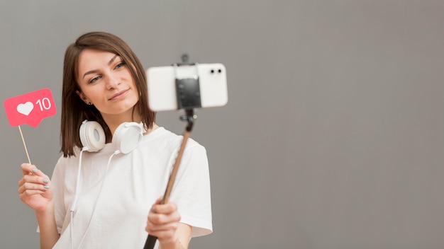 beautiful woman recording video with copy space