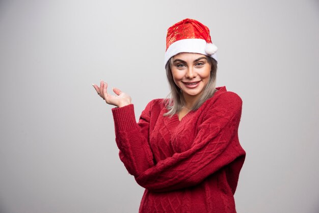 Beautiful woman in red sweater smiling widely.