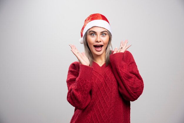 Beautiful woman in red sweater surprised about her present.