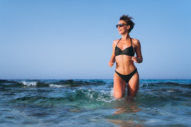 Beautiful woman running out of the ocean