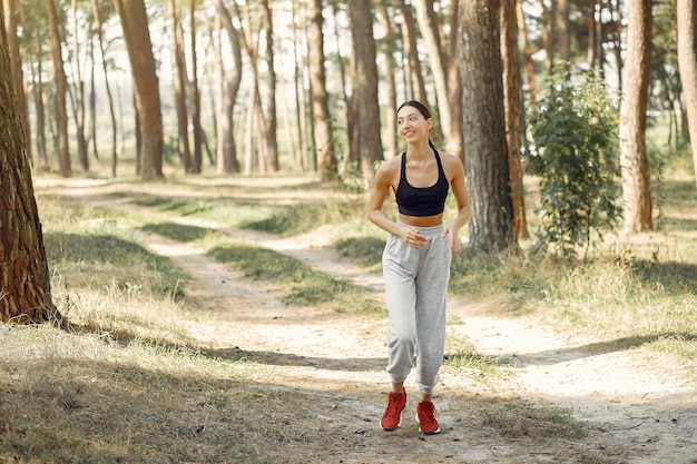 Beautiful woman runs in a summer park