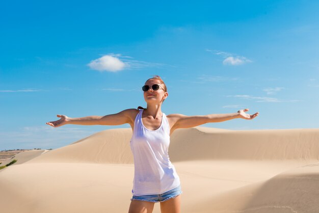 Beautiful woman in sand dunes