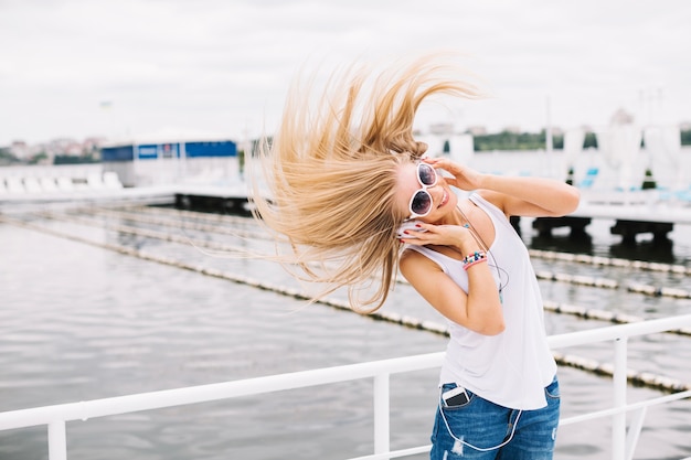 Beautiful woman shaking head near river