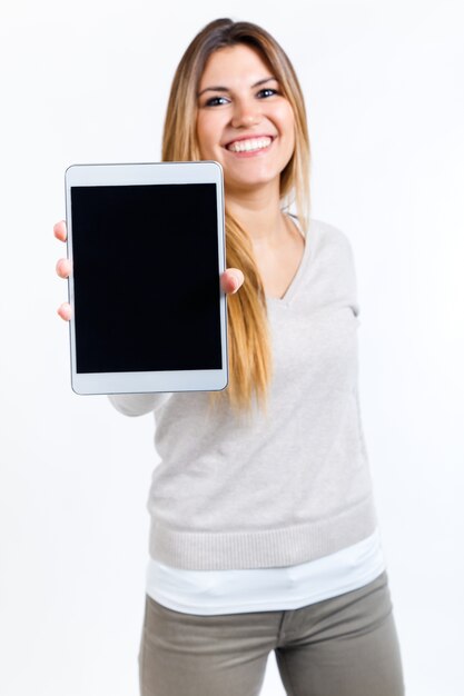 Beautiful woman showing digital tablet. Isolated on white.