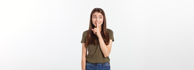 Beautiful woman showing finger over lips isolated on a white background