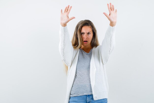 Free photo beautiful woman showing stop gesture in jacket and looking distrustful , front view.