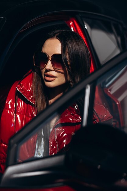 Beautiful woman sits in her car