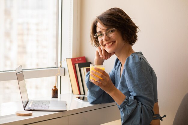 Beautiful woman sitting at home smiling