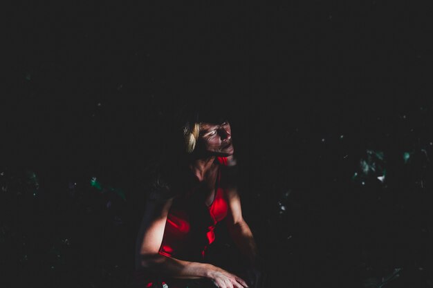 Beautiful woman sitting in shadow