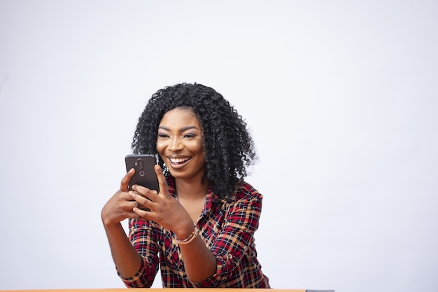 Beautiful woman smiling and looking at her phone