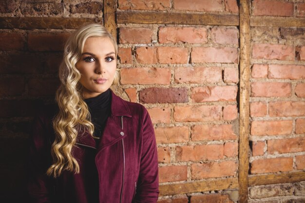 Beautiful woman standing against wall