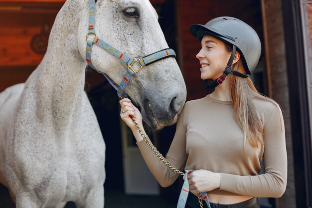 Beautiful woman standing with a horse