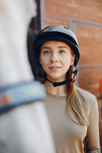 Beautiful woman standing with a horse