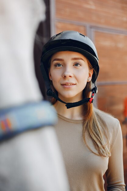 Beautiful woman standing with a horse