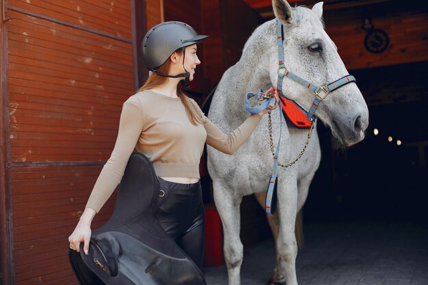 Beautiful woman standing with a horse