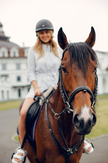 Beautiful woman standing with a horse